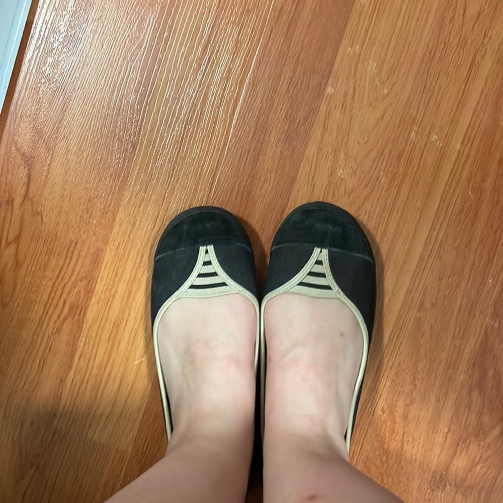 Black slip on shoes. Cross between tennis show and slip on.